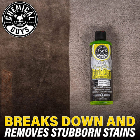 Chemical Guys Foaming Citrus Fabric Clean, Carpet and Upholstery Cleaner bottle on stained fabric background, 16 oz.