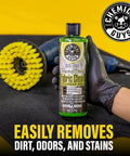 Chemical Guys Foaming Citrus Fabric Clean, Carpet and Upholstery Cleaner - Car Carpet Cleaner for Seats, and Floor Mats, Safe for Home, Office & More, Citrus Scent - 16 oz bottle held by gloved hand with cleaning brush on mat