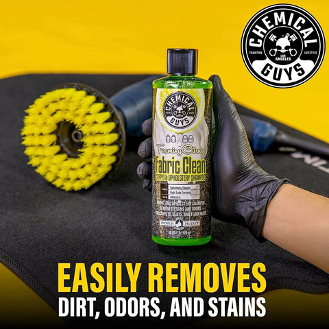 Chemical Guys Foaming Citrus Fabric Clean, Carpet and Upholstery Cleaner - Car Carpet Cleaner for Seats, and Floor Mats, Safe for Home, Office & More, Citrus Scent - 16 oz bottle held by gloved hand with cleaning brush on mat