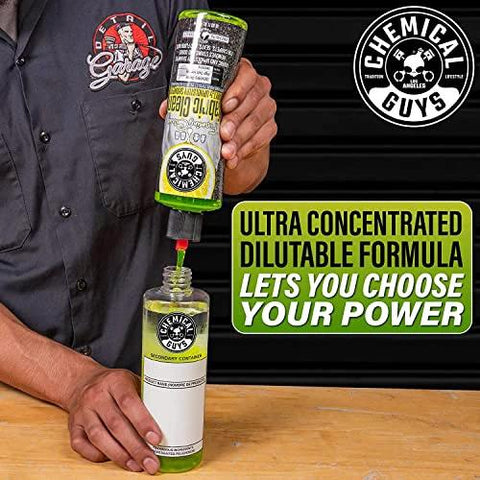 Person pouring Chemical Guys Foaming Citrus Fabric Clean into a secondary bottle, focused on its ultra concentrated formula.