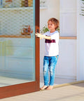 Child standing on Solid Red Oak Interior Threshold Wood Oak Threshold Transition Overlap Threshold Doorways Reducer Threshold (36 x 3 x 1 Inches) in a doorway.