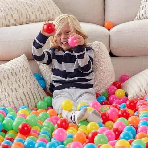 Child playing in colorful BPA Free Crush-Proof Plastic Ball Pit Balls with Storage Bag, Toddlers Kids 12+ Months, Pack of 400 Balls, 6 Bright Colors