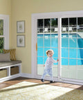 Sliding Glass Door Lock And Bolt For Patio Doors Childproof Safety Rail Lock For Top Or Bottom Mount Fits Most Sliding Doors And Windows White 1 Pack Easy Install To Stop Drafts And Water Seepage installed on patio door with child nearby