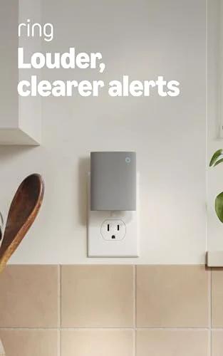 Sleek white chime plugged into wall, offering enhanced audio for real-time alerts; Chime Newest Model With Enhanced Audio For Real Time Alerts You Can Hear From Anywhere Easy Plug In Setup Simple WiFi And Bluetooth Connectivity Sleek White Design And Clear Louder Notifications Throughout Your Home
