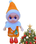 Toy elf doll in orange outfit standing next to decorated Christmas tree with similar elf as ornament