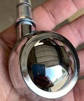 Hand holding a chrome-plated 1.5 inch Shepherd ball caster wheel for smooth motion in automation systems, single item close-up