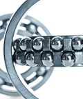 Close-up of 12 Pack Five Eighth Inch Chrome Steel Bearing Balls G25 Precision Grade Mirror Finish in a ball bearing assembly.
