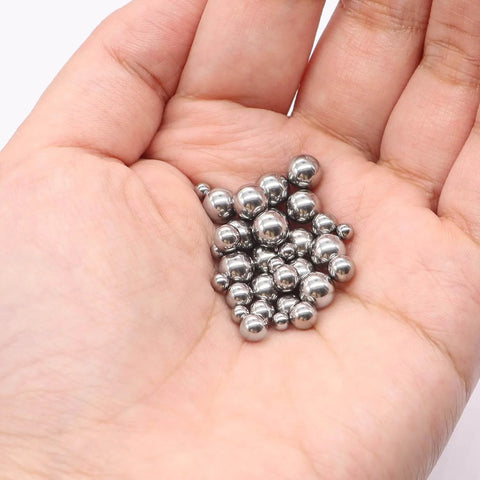 Hand holding 490Pcs Bicycle Bearing Balls Kit Six Sizes Precision Chrome Steel Balls Assortment