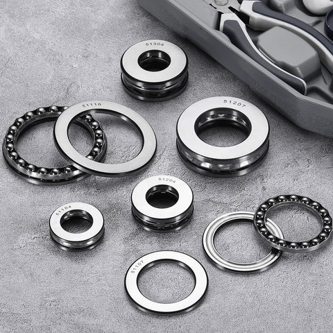 Chrome steel ball bearings and races, assorted sizes, with visible part numbers on metal rings.