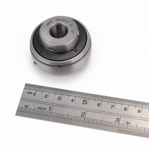 Chrome Steel Insert Ball Bearings UC201-8 Bore Half Inch Sealed With Set Screw Pre Lubricated with ruler for size reference.