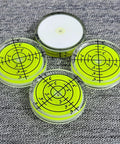 Four small circular bubble levels on a textured surface, 32x7mm acrylic, used for DIY woodworking alignment, Pro Grade Easy To Read.