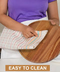 Two Pack 10 Inch Acacia Wood Lazy Susan Turntables being wiped clean with cloth, shows durability and easy maintenance