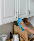 Person cleaning kitchen cabinet with 10 Pack Antique Brass Cabinet Pulls Three And Three Quarter Inch Center To Center Spacing Dresser Handles.