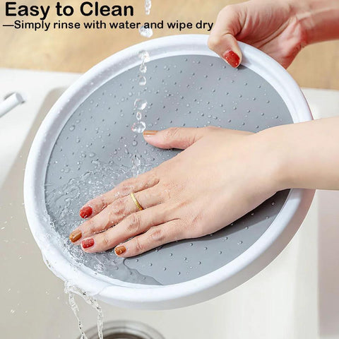 A person rinsing a 10 Inch Lazy Susan Turntable for Kitchen Cabinets and Refrigerators in a sink, highlighting easy cleaning.