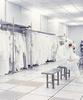 Cleanroom environment with person in protective gear, emphasizing use of White PVC Cleanroom Tape 2 Inch By 36 Yards One Roll That Handles Solvents
