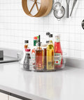 Clear 12 Inch Lazy Susan Turntable Set With Handles 4 Pack Acrylic Spinning Organizer on countertop with condiments and sauces