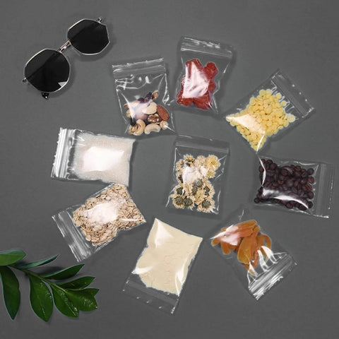 400 Pcs Clear 3x4 Inch Jewelry Bags 2 Mil Resealable Zip Bags for Small Business Storage Candy displayed with various contents