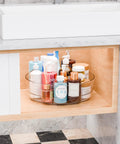 Clear 12 Inch Lazy Susan Turntable Set With Handles 4 Pack Acrylic Organizer in bathroom cabinet with cosmetics.