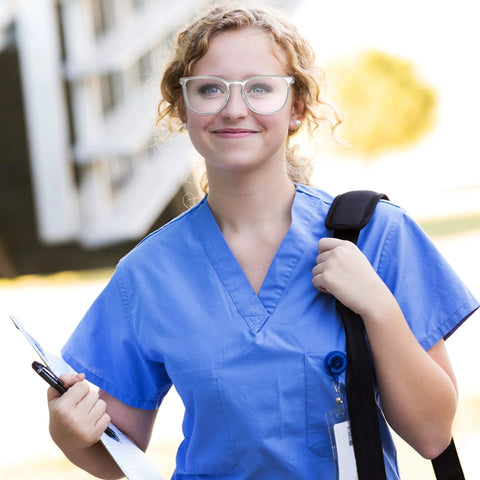 Person wearing Clear Anti Fog Safety Glasses With Anti Scratch ANSI Z87 1 Blue Light Blocking, holding clipboard and backpack.