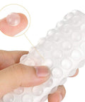 Hand holding 200 Pcs Clear Cabinet Bumpers Self Adhesive Soft Close Quiet Cupboard Door Bumpers Pads For Kitchen Cabinets Drawers
