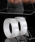 Double Sided Nano Tape 2 Inch By 33 Feet Heavy Duty Mounting Gel Tape clear rolls shown with a piece being peeled.