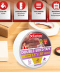 Clear Double Sided Tape Removable 1.5 Inch By 30 Yards shown on a table with packaging and crafting tools in background.