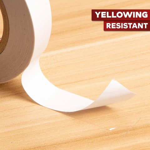 Close-up of Clear Double Sided Tape Removable 1.5 Inch By 30 Yards unrolled on wooden surface, yellowing resistant.
