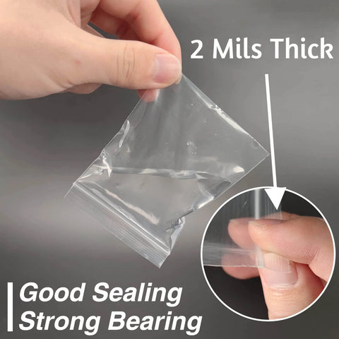 Hand holding a 400 Pcs Clear 3x4 Inch Jewelry Bag 2 Mil Resealable Zip Bag, showcasing thickness and resealable feature for storage.