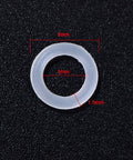 Close-up of a single clear O-ring with 8mm outer, 5mm inner diameter, and 1.5mm thickness for 200 Pieces O Ring Keyboard Dampeners For MX Switches And Mechanical Keys, Clear Rubber Dampeners With Plastic Storage Box, Replacement Dampers For Quiet, Smoother, Quieter Keystrokes, Durable, Easy Install.