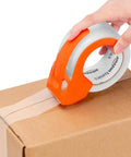 Applying Strong Clear Packaging Tape 1.88 Inch By 54.6 yd 12 Pack With Low Odor Acrylic Adhesive to a box using dispenser