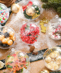20 PCS Clear Plastic Fillable Balls Ornaments, 3.15 Inch Christmas ornament balls filled with festive decorations on snowy background