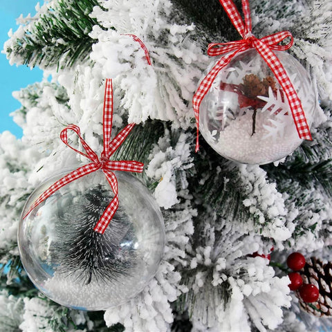 20 Pack 4-Inch Clear Plastic Fillable Ornaments Ball, decorated with ribbons and displayed on a snowy Christmas tree