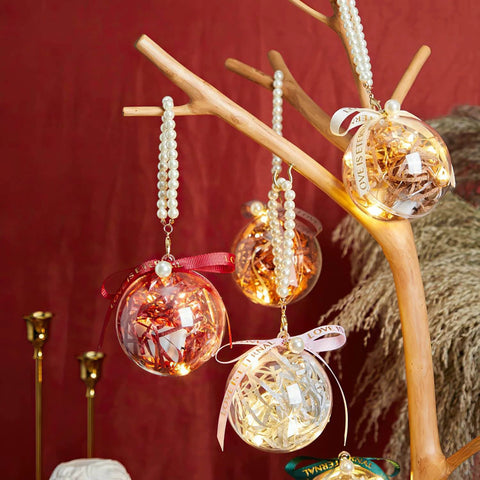 20 Pack 4-Inch Clear Plastic Fillable Ornaments Ball, for Christmas, Wedding, Party, Home Decor hanging on decorative branch.