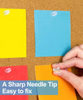 Hand pinning notes on a cork board with Clear Push Pins Set With Steel Point And Plastic Head, 2400 Pieces In 12 Boxes