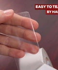 Close-up of hand tearing Clear Double Sided Tape Removable 1.5 Inch By 30 Yards A Real Workhorse For Gift Wrapping and more