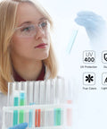 Woman wearing Clear ANSI Z87.1 Safety Eyewear For Men And Women Scratch Resistant Lenses in lab, handling test tubes.