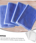 Blue shrink bags displayed on wooden table, showcasing tight seal quality for packing items like essential oil and eyelash bottles.