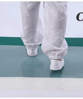 Person stepping on Sticky Mats For Cleanrooms And Laboratories 60 By 90 Cm 10 Pack 300 Sheet Adhesive Debris Mats Anti Dust Anti Static