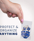 Hand holding Clear Plastic Reclosable ZIP Bags 2 Mil 2x3 Inch Case of 100, containing blue jewelry for safe storage.