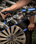 Person using UPGRADE 1/2" Drive Click Torque Wrench 10-180ft.lb on car engine and wheel, dual-direction adjustable, blue handle.