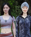 Two people wearing clip on running lights for hands-free visibility; one clipped to a vest, another to a hat, for night runs and dog walks.
