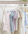 Space saving 50 pack slim plastic hangers organizing shirts and dresses in a neat, space-efficient manner on a clothing rack.