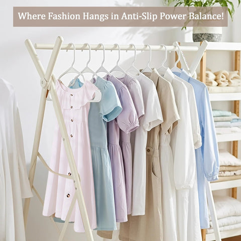 Space saving 50 pack slim plastic hangers organizing shirts and dresses in a neat, space-efficient manner on a clothing rack.