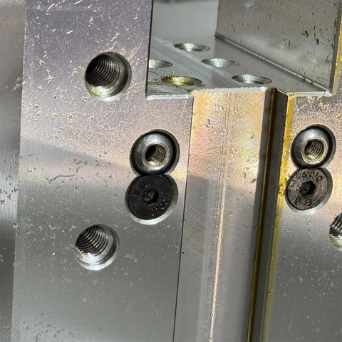 Metal surface with threaded holes showing ten pack M6 12mm 304 stainless steel ball coolant nozzles with screw lock for CNC lathes and milling machines