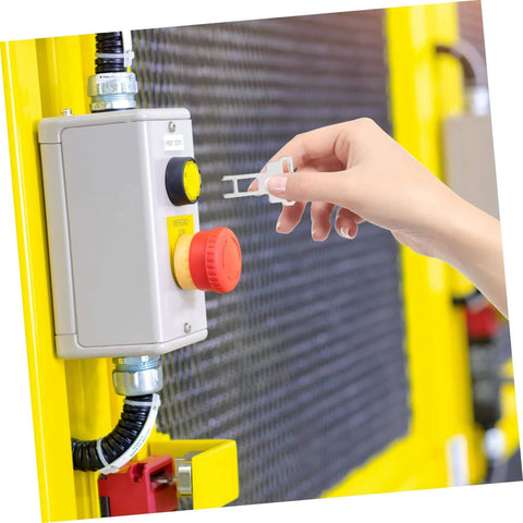 Hand inserting CNC Mill Safety Actuating Key For Industrial Door Locking And Machine Mechanism into light switch panel.