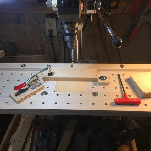 Heavy Duty 5 Pack Hold Down Toggle Clamps With Quick Release on a pegboard workbench, 200 lb capacity, antislip red vinyl handles.