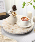 12 inch mother of pearl lazy susan turntable with marble pattern, used for serving coffee on a decorative wooden tray.