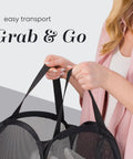 Person holding a Collapsible Mesh Pop Up Hamper With Wide Opening And Side Pocket Breathable Sturdy Foldable Space Saving Design