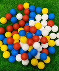 Practice Golf Balls - 24 Pack Colored Plastic Balls 41mm Training Realistic Feel Limited Flight, golf balls scattered on grass.