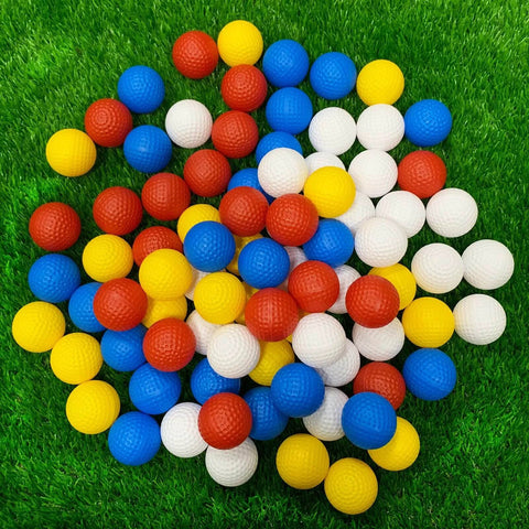 Practice Golf Balls - 24 Pack Colored Plastic Balls 41mm Training Realistic Feel Limited Flight, golf balls scattered on grass.